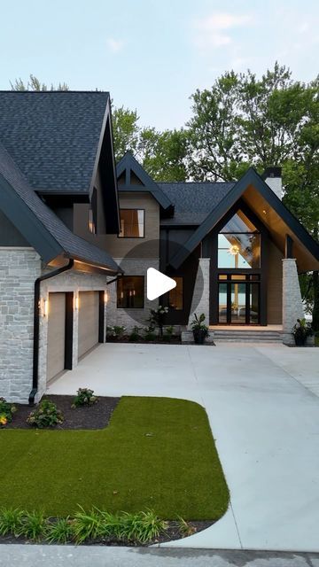 Hamed Homes on Instagram: "All the feels…
⁣
⁣
Design Architect:⁣ @david.charlezdesigns 
Interior Design:⁣ @carbon6interiors 
Landscape Architect:⁣ @earthlandarch 
Windows:⁣ @andersen_windows 
Exterior Siding:⁣ @deltamillworks 
⁣
⁣
⁣
⁣
⁣
⁣
#custombuild #newhomes #customhome #homebuilder #build #indiana #custombuilt #customhomes #newhomeconstruction #buildersofig #buildersofinsta #itsahamedhome" Stone With Black Siding, Modern Roof Design Architecture, L Shaped Homes Exterior, L Shaped Houses Exterior, Desert Modern House, Ranch Home Designs, Modern Roof Design, L Shaped House, Ranch House Designs