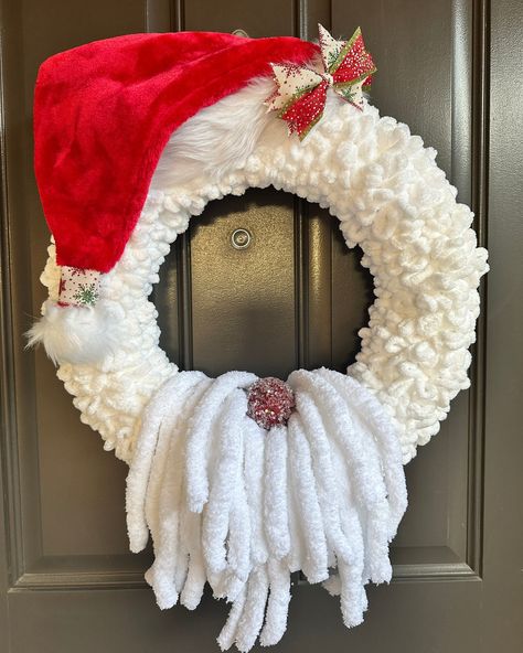 Christmas Santa Claus Wreath, Holiday Wreath, Yarn Wreath.  This is such a cute wreath  on your front door or just about anywhere in your home.  It is made on a white foam wreath and once covered in the white fun loopy yarn, red Santa hat, chunky white yarn for the beard, it measures 20" x 18" x 5.5".  We topped it off with a fun red ornament with acrylic sparkle on the top and a small messy bow and ribbon wrapped around the end of the hat.   You can display this wreath inside or outside but you definitely don't want to get this wet as it is all yarn and fabric for the hat.  If you put it outside, just make sure it is not in direct sunlight or any harsh weather.   All our wreaths are handmade in a smoke-free environment and shipping includes securing it with chenille stems to lessen moveme Christmas Mini Wreaths, Santa Wreaths Diy, Chunky Yarn Pumpkins Diy, Pool Noodle Wreath Diy, Diy Pool Noodle Crafts, Loopy Yarn Wreath, Diy Yarn Wreath Tutorial, Christmas Wreath Ideas Diy, Unique Wreath Ideas