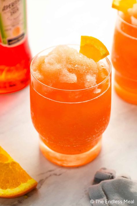 If you're Googling 'frozen Aperol spritz,' we should be friends because I love the way you think. As an avid Aperol lover myself, I was only one hot day from discovering this delicious slushy cocktail. It's a quick and easy summer drink that you can make as soon as the craving strikes—no need to wait for any ingredients to freeze! In fact, if you start right now, you'll be sipping the ultimate summer cocktail in just five minutes! #theendlessmeal #aperol #aperolspritz #cocktail #drink Frozen Aperol Spritz, Aperol Spritz Recipe, Easy Summer Cocktails, Spritz Recipe, Christmas Punch Recipes, Christmas Punch, Peach Juice, Cocktail Drink, Summer Cocktail Recipes