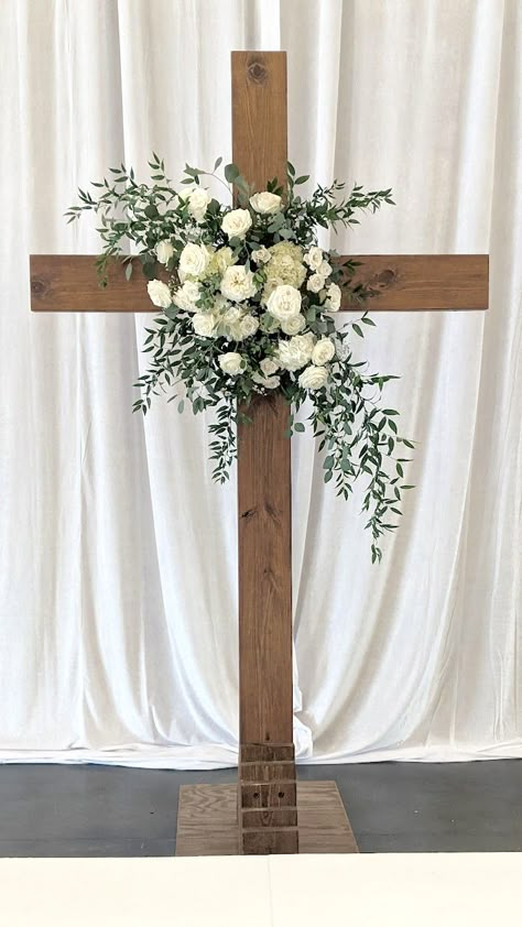 Cross florals in white and green for wedding at The Fields at Skycrest. White Flowers On Cross Wedding, Cross Wedding Alter Indoor, Floral Cross Arrangement, Cross Floral Wedding, Wedding Cross Ideas, Cross At Alter Wedding, Alter Cross For Wedding, Decorated Cross For Wedding, Cross Background Wedding