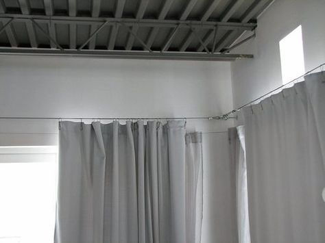 How to DIY your very own Ikea style custom curtain cable system. I love the Dignitet from Ikea, but it doesn't give you the versatility that making your own does. Perfect for sliders, arches, windows, canopy beds, kid's artwork displays.. the list goes on and on. Cover with a valance if you like the traditional look, leave exposed for a modern industrial feel. Industrial Loft House, Corner Window Treatments, Balcony Curtains, Bathroom Window Treatments, Balkon Decor, Tension Rods, Trendy Apartment, Ikea Curtains, Window Treatments Bedroom