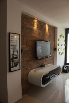 slightly inset stone or brick wall section for tv (more traditional media console beneath) Living Room With Brick Wall, Lcd Wall, Simple Living Room Designs, Ruang Tv, Wall Mounted Tv Cabinet, Tv Mounted, Tv Fal, Theater Rooms, Brick Interior