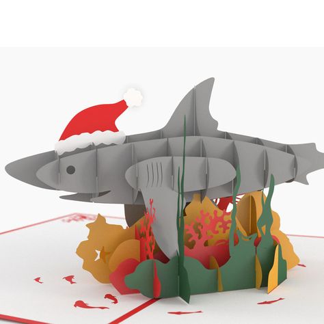 The cover of the red Christmas Shark Pop Up Christmas Card features a 3D illustration of a fun loving shark smiling and wearing a Santa hat. Once opened this amazing card reveals a three-dimensional a Shark Pop Up Card, Slice Form, Crochet Start, Christmas Shark, Pop Up Christmas Cards, Popup Cards, Christmas Card Online, Send Christmas Cards, Pop Up Art