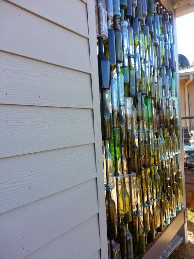 A Husband And Wife Want Privacy On Their Porch, But Instead Of Curtains...THIS Is Incredible! Rustic Chic Wall Decor, Sea Glass Window Art, Wine Bottle Wall, Bottle Trees, Empty Wine Bottles, Wine Bottle Art, Bottle Garden, Bottle Wall, Metal Tree Wall Art