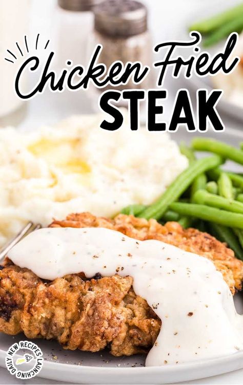 close up shot of Chicken Fried Steak topped with homemade gravy and served with mashed potatoes and green beans on a plate Steak With Gravy, Chicken Fried Steak Recipe, Fried Steak Recipes, Cube Steak Recipes, Country Fried Steak, Fried Steak, Cube Steak, Chicken Fried Steak, Quick And Easy Dinner