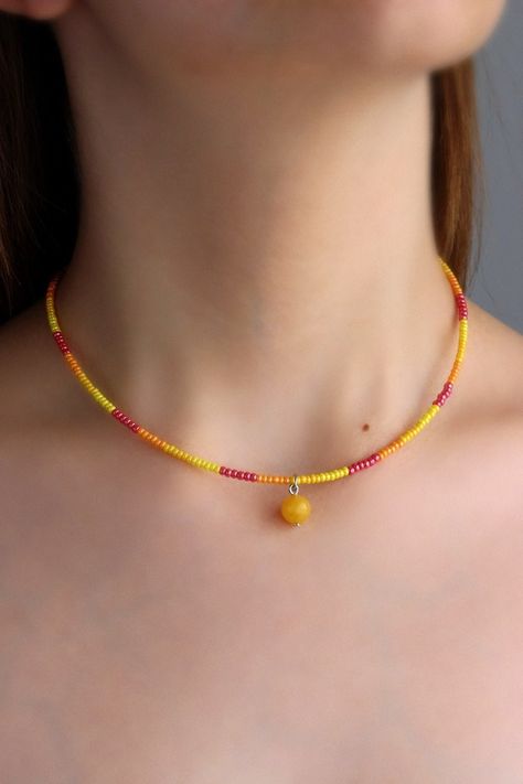 Pretty summer choker necklace with natural polished agate stone 8 mm bead, yellow, red plastic seed beads, two layers of strong nylon thread, silver tone claps and silver tone lobster claw with stainless steel chain. Perfect for everyday wear or a lovely gift! The length of necklace is about 39.5 cm or about 15.5 inches and about 4 cm of adjustable length chain. Other necklaces you can find in my store in the necklace section. https://www.etsy.com/shop/NaTavelli?section_id=14843046&ref=shopsecti Beaded Summer Necklace, Beaded Choker Ideas, Yellow Beads Necklace, Orange Necklaces, Golden Choker, Orange Beaded Necklace, Seed Beads Necklace, Summer Choker, Plastic Necklace