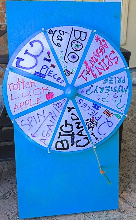 Our Hinze homemade Halloween Spin the Prize Wheel was a hit with the trick-or-treaters! I made it with a lazy susan, piece of wood, spray paint, dry erase vinyl sheet cut into pie pieces, glue, nails, a dowel,  and a cable tie. (FYI - use screws instead of nails so they won't fall out when the kids grab them to spin the wheel). Halloween Spin The Wheel Game, Halloween Spin The Wheel, Spin The Wheel Game Ideas, Haunted House Outfit, Spinning Wheel Game, Cardboard Challenge, Wheel Of Fortune Game, Diy Halloween Candy, Halloween Prizes