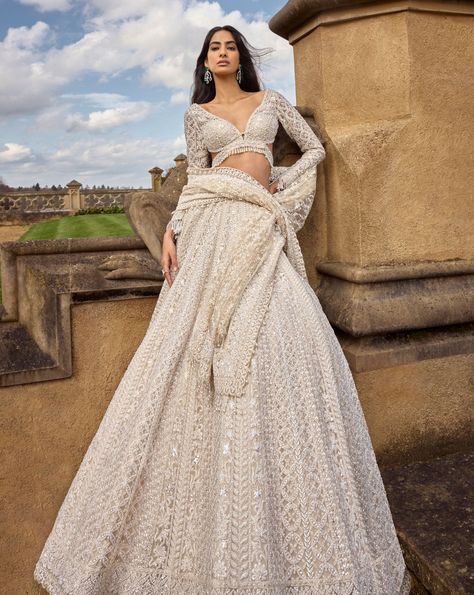 This ivory lehenga set features intricate embroidery in thread, pearl and sequin in a linear pattern. The full sleeves blouse shows exaggerated tassels at the wrist. The dupatta has four sided heavy embroidery with a jaal in the centre.From Seema Gujral's A Royal Affair collection. DELIVERY TIMEPlease allow 8-12 weeks for your outfit to arrive. FABRIC DETAILSNet Professional cleaning only. Reception Outfit For Bride Indian, Indian Wedding Outfit Bride, Pearl Lehenga, Full Sleeves Blouse, Indian Wedding Reception Outfits, Ivory Lehenga, Engagement Looks, Embroidery Lehenga, Chinese Fancy Dress