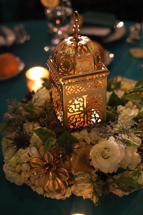 Floral Ring Centerpiece featuring a Gold Lantern - Clair Pruett Studios Indian Lantern Centerpieces, Moroccan Centerpiece Ideas, Egyptian Centerpieces, Multicultural Decorations, Indian Centerpieces, Floral Ring Centerpiece, Eid Dinner, Indian Lanterns, Egypt Wedding