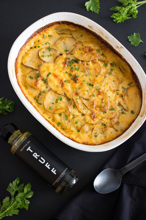 Savory Potatoes Au Gratin | TRUFF Truffle Potatoes, Savory Potatoes, Black Truffle Oil, Cheddar Cheese Sauce, Potatoes Au Gratin, Truffle Oil, Russet Potatoes, Sliced Potatoes, Cheese Sauce