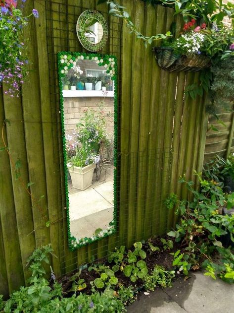 I had just took down a boring mirror as I was replacing it, with another.I didn't want to throw it away, so I thought it would look good in the garden. I had just the spot on a fence outside my back door. I am editing this post as I have just come home to a mess. There are glass stones on the ground, so the hot melt glue is not suitable for outside use. We have had a heat wave then a rain storm and it took its toll on my mirror. Use glue recommend by Hometalkers that have posted a reply on ... How To Make An Outdoor Mirror, Mirrors In Gardens, Mirrors In Garden, Mirrors In The Garden, Mirror Outside, Repurposed Candle Holders, Concrete Bird Bath, Topiary Diy, Garden Globes