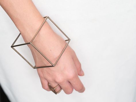 Printed using stainless steel powder, this 3D printed bracelet comes out looking like a perfect silver cube. Modern Geometric Everyday Jewelry, Minimalist Adjustable Geometric Jewelry, Modern Adjustable Geometric Jewelry, Luxury Elegant Geometric Jewelry, 3d Printed Bracelet, Nickel-free Geometric Gold Jewelry, Geometric Jewelry Design, Geometric Bangle, 3d Printing Fashion