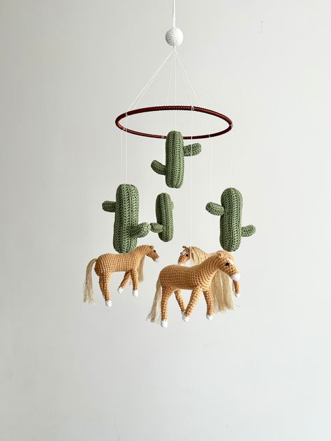 Handmade horses baby mobile, crochet horses baby nursery, crochet horse theme baby mobile, shower gift.100% pure handmade  - Material: Cotton  The mobile includes: -4 Cactuses ( 13cm/ 3.7 inches) ( sage green color) - 3  horses - 15cm/4.5inches ( light brown colors)  -  circular mobile frame- 25 cm (10 inches) length Designed and made in a smoke free pet free home, this is a perfect mobile for any baby, or as a gift for baby shower. It is made with lot of love and care. The mobile is has a Croch Horse Room Ideas, Horse Baby Shower Ideas, Crochet Horses, Baby Mobile Crochet, Nursery Crochet, Southwest Nursery, Horse Crochet, Cowboy Nursery, Horse Nursery