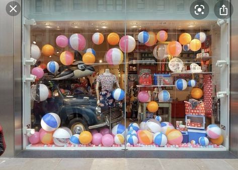 I would use this prop in a beach themed window display. These beach balls would look great alongside some bathing suits, sandals, sunglasses, hats and other summer clothing. Boutique Window Displays, Summer Display, Summer Window Display, Store Front Windows, Summer Store, Window Display Retail, Summer Window, Store Window Display, Beach Balls