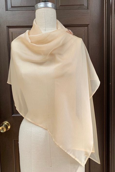 "Very light and airy shawl made out of iridescent chiffon. Easily draped and fixed with broach or tied at back to transform into shrug.  Great shear cover up for top of your body.  Poly chiffon prevent from wrinkles, easy to take care.  Size of shawl does not overpowering with lots of fabric when wearing  Size around 22\"x 60\" Fabric  Champagne Iridescent Chiffon  You have choices of broach: 1. Pearl flower 2. Pink Gold ornament" Shawl Styling, Scarf Outfits, Blush Shoes, Shawl Design, Scarf Coverup, Ivory Wedding Gown, Shawl Style, Accessories Inspiration, Gold Ornament