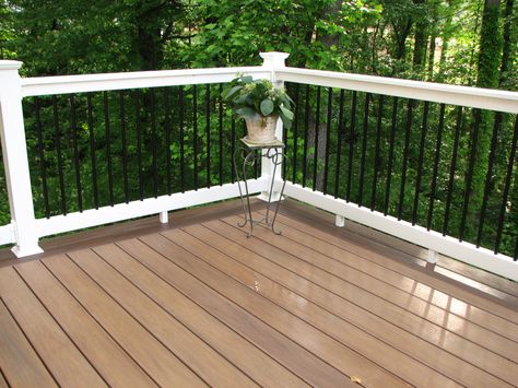 Longevity black aluminum balusters with white PVC #deck railing and WOLF PVC decking amberwood flooring. Aluminum Porch Railing, Decking Railing, Metal Deck Railing, Aluminum Railing Deck, Deck Spindles, White Deck, Deck Railing Design, Pvc Decking, Deck Colors