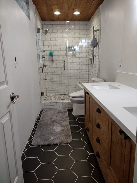 Hexagon tile hex tile subway tile master bathroom black grout wood vanity black drawer pulls Octagon Bathroom Tile, Black Hexagon Tile, Hickory Cabinets, Black Interior Design, Basement Bathroom, Basement Remodel, Hexagon Tiles, Basement Remodeling, Remodel Ideas