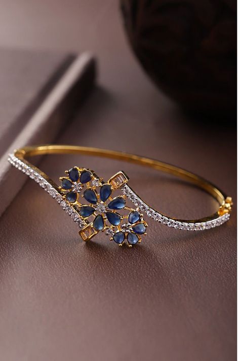 Navy blue gold plated handcrafted Bangle style bracelet Material and stone type: Brass with artificial stones Plating: Gold-Plated Closure: Interlock #goldplated #bangle #braclet #banglestylebracelet Bangle Type Bracelet Gold, Indian Bracelets, Antique Gold Bracelet, Bracelets Pandora, Solid Gold Bangle, Blue Stones Jewelry, Gold Bangles For Women, New Gold Jewellery Designs, Diamond Bracelet Design