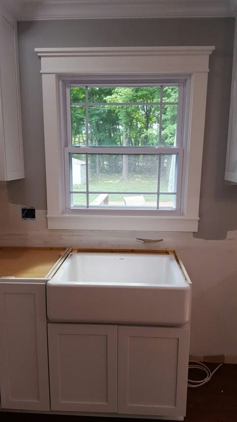 My new kitchen dream centered around a farmhouse apron sink. I chose this cast iron one by Kohler with a right side drain. I melted when I saw  it installed! The window was replaced with a modified prarie style, and replaced the "modern" trim with craftsman style molding. Bathroom Window Trim, Craftsman Cottage Interiors, Craftsman Molding And Trim, Window Trim Ideas Interior, Craftsman Style Molding, Kitchen Remodel Farmhouse, Beech Kitchen, Craftsman Window Trim, Small Bathroom Window