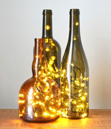 Turn any glass bottle into a glowing focal point with little more than a string of LED Christmas lights and a diamond hole saw drill bit. Diy Christmas Lights, Christmas Lamp, Christmas Wine Bottles, Wine Bottle Art, Wine Bottle Diy Crafts, Wine Bottle Diy, Lighted Wine Bottles, Led Christmas Lights, Bottle Lights