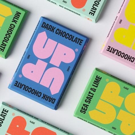 Pentawards on Instagram: "@freytaganderson's identity and packaging design for @upupchocolate. The symmetrical, fully rotatable design was created to physically represent the brands positive messaging. The impactful colour palette is inspired by the vibrancy of the Colombia where the cocoa is farmed, bringing with it some fun as well as a serious commentary on how the chocolate industry currently operates. #pentawards #packagingdesign #packagingdesigninspo #packaginginspiration #foodpackaging Fun Food Packaging, Chocolate Brand Design, Funky Packaging Design, Candy Packaging Ideas, Candy Branding, Snacks Package, Chocolate Branding, Snack Brands, Chocolate Packaging Design