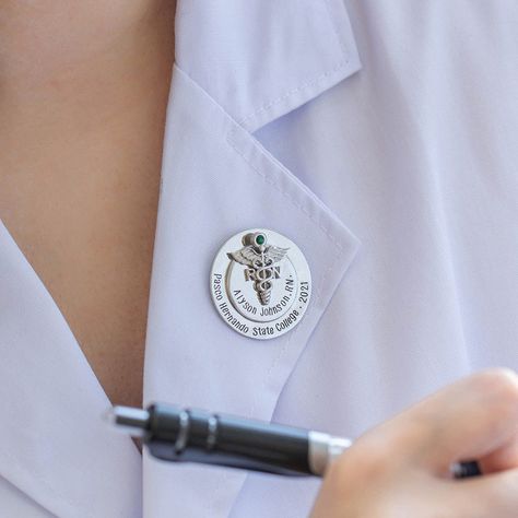 Our Personalized Nursing Pin is an ideal gift for new or soon-to-be nurses– a little token of appreciation they'll cherish for life. Our Personalized Nursing Pin is designed to welcome newly graduated nurses into the realm of the noble profession of nursing. At the center of the pin, you'll find the medical symbol embellished with a colored birthstone, along with the professional degree initials. There is provision to add personal statements such as the name of the receiver, and the name of the Pinning Ceremony Nurse, Personal Statements, Personalized Gifts For Nurses, Medical Graduate, Pinning Ceremony, Unique Graduation Gifts, Nursing Pins, Custom Gift Cards, Nursing Accessories