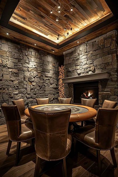 A rustic poker room with stone walls, leather chairs surrounding a poker table, and a wooden ceiling with warm lighting. A fireplace adds a cozy touch to the sophisticated gaming space. Bar Room Ideas In House Rustic, Mountain House Game Room, Poker Room Man Cave, Ultimate Game Room, Luxury Game Room Design, Rustic Textured Walls, Home Poker Room, Tavern Game Room, Whiskey Room Man Caves