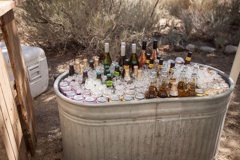 Brilliant use of a horse trough for keeping drinks on ice. Stock Tank Cooler Wedding, Trough Drink Station, Stock Tank Drink Cooler, Metal Tub Cooler Wedding, Water Trough Wedding Drinks, Outdoor Wedding Trash Can Ideas, Horse Trough Drinks Wedding, Beer Trough Wedding, Wedding Drink Trough