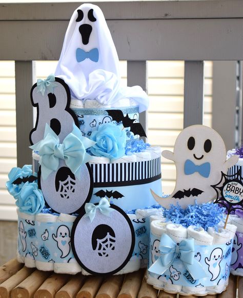 "Blue Ghost Diaper Cake Baby Shower, Boy Blue Halloween Baby Shower Centerpieces Decorations, Blue Ghost Shower Party Decor - S0011 This Gorgeous Blue Ghost Diaper 3 Tiers Cake is the perfect centerpieces for your baby shower. We can match any shower theme. ❤  Description: ♡ 3 TIER DIAPER CAKE= ❤ This DIAPER CAKE is decorated with ghost theme in blue, white & black colors.  ❤   Measures 18\" H x 12\" W (approx.) ❤  The diapers used are Pampers Swaddlers ( Sizes: 1 ). Quantity: 80 - 85. ❤ The dia Halloween Diaper Cake Ideas, Ghost Baby Shower Ideas, Halloween Baby Shower Centerpieces, Halloween Diaper Cake, Shower Baskets, Ghost Theme, Blue Ghost, Blue Halloween