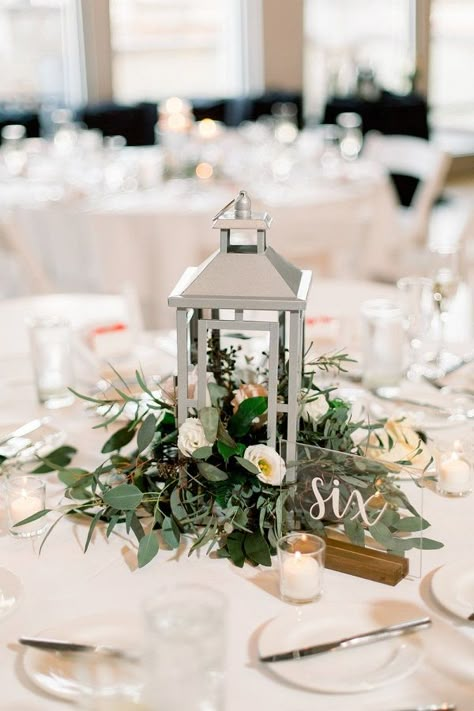 Wedding Table Centerpieces Lanterns Simple, Lanterns With Greenery Centerpieces, Sweetheart Table Wedding With Lanterns, Lantern Centre Pieces, Lantern Floral Centerpieces, Spring Reception Decorations, Spring Floral Table Centerpieces, Wedding Table Decor With Lanterns, Lantern Flower Arrangements