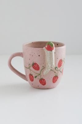 Peek-a-boo cat mug in a cute, kitschy design. Features a ceramic construction with a painted, speckled finish, topped with adorable strawberries and a handle at one side. **Content + Care** \- 100% Stoneware \- Hand wash \- Food safe | Urban Outfitters Peeking Cat Mug - Pink