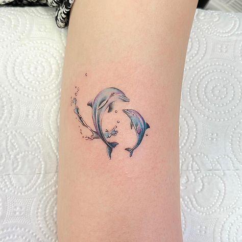 Dive Into The World Of Dolphin Tattoos: Discover Stunning Ideas And Designs Matching Dolphin Tattoos, 2 Dolphin Tattoo, Dolphin Tattoo Ideas, Dolphin Tattoo Meaning, Dolphin Tattoos, Dolphin Tattoo, Purple Tattoos, Dolphins Tattoo, Lighthouse Tattoo