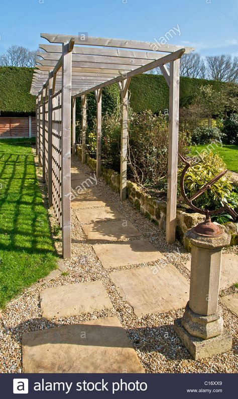 Download this stock image: A pergola is a wooden walkway frame used in landscaping a garden - C16XX9 from Alamy's library of millions of high resolution stock photos, illustrations and vectors. Pergola Over Walkway To Front Door, Trellis Walkway, Pergola Walkway, Walkway Design, Outdoor Walkway, Wooden Walkways, Garden Arbor, Professional Landscaping, Garden Walkway