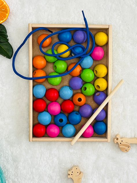 Welcome to our Wooden Lacing Toy Rainbow - where learning meets vibrant playtime! Packed with colorful wooden beads and laces, this toy adds excitement to sorting and aligning tasks, making education a fun adventure. It's a fantastic supporter of Montessori learning, specifically designed to enhance kids' dexterity and color recognition skills. Crafted with precision, our Montessori bead lacing toy fosters hands-on learning experiences, perfect for refining fine motor skills and hand-eye coordin Lacing Beads Activity, Rainbow Montessori, Lacing Toy, Montessori Learning, Fun Adventure, Montessori Baby, Color Sorting, Toddler Learning Activities, Baby And Toddler