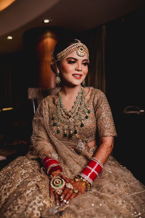 This bride in her golden lehenga and kundan jewellery set, is giving bridal goals.  For more such beaautiful makeup, Book your wedding Makeup Artist on ShaadiSaga.com   | Shaadisaga | Bridal Lehenga | Bridal Makeup | Mehendi | Bridal Jewellery | Maang Tikka | Chooda | Bridal Portrait Golden Bridal Lehenga, Fairytale Bride, Golden Lehenga, South Indian Bridal Jewellery, Gold Lehenga, Lehenga Jewellery, Bridal Chura, Bridal Lehenga Collection, Bridal Makeup Wedding