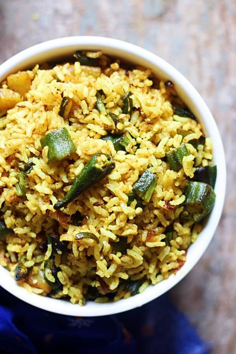 Okra rice or bhindi rice is one of the easiest rice recipes you can make for lunch box. With just very few ingredients and a handful of cooked rice or leftover rice, this okra rice comes together. Moderately spiced and very flavorful bhindi rice is a fuss free choice for lunch. Kids will love this with a simple salad or potato chips. Here is how to make easy okra rice for lunchbox. Okra And Rice Recipes, Okra Rice Recipes, Indian Rice Recipes Vegetarian, Okra Rice, Lunch Box Rice, Ghee Rice Recipe, Veg Fried Rice Recipe, Curry Rice Recipes, Veg Pulao Recipe