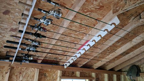 Ceiling Fishing Rod Storage, Rod Racks Fishing, Garage Fishing Rod Storage, Fishing Rod Holders For Garage, Hunting Storage Room, Hunting Storage Ideas, Fishing Pole Storage Diy, Fishing Organization Ideas, Fishing Rod Storage Diy