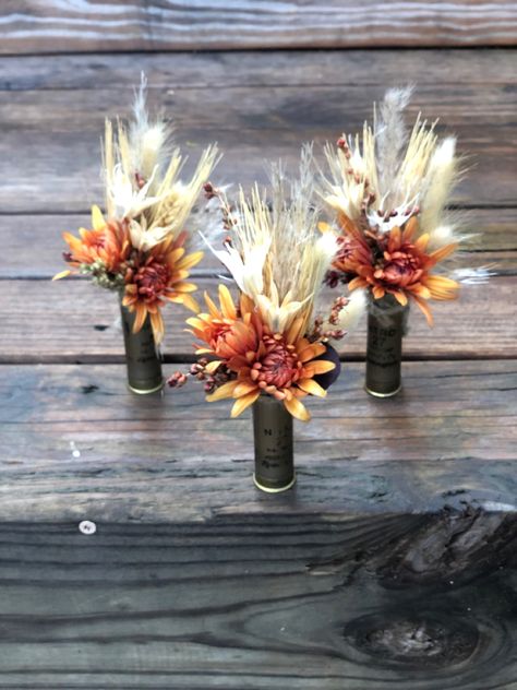 Logger Themed Wedding, Groomsmen Boutonniere Rustic, Country Wedding Flowers Rustic, Western Bouteniers, Shotgun Boutineers, Shell Casing Boutonniere, Shotgun Shell Boutineer, Shotgun Shell Boutonniere Diy, Shotgun Wedding Ideas