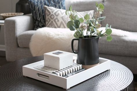 Tips to Style a Round Coffee Table in your Living Room | The DIY Playbook Tray On Round Coffee Table, Trays On Ottomans Ideas, Black Coffee Table Decor, Style A Round Coffee Table, Black Round Coffee Table, Styling A Coffee Table, Living Room Tray, Coffee Table Crate And Barrel, Coffee Table Decor Tray