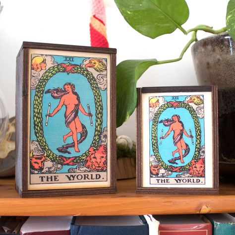 The World card represents an ending to a cycle of life, a pause in life before the next big cycle beginning with the fool. It is an indicator of a major and inexorable change, of tectonic breadth. You can't live your life in a box, but you can snag this world card tarot box for yourself on our website (link in bio). World Card Tarot, Handmade Wooden Gifts, Birch Box, The World Tarot Card, The World Tarot, Deck Accessories, Angel Guide, Textile Wall Art, Stash Box