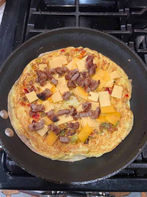 Eggs, meats, and cheeses cooking in a quesadilla on a black pan Egg Quesadilla, Black Pan, Breakfast Quesadillas, Breakfast Quesadilla, Chicken Breast Recipes Baked, Waffle Cookies, Lunch Appetizers, Rice Ingredients, Breakfast Sandwiches