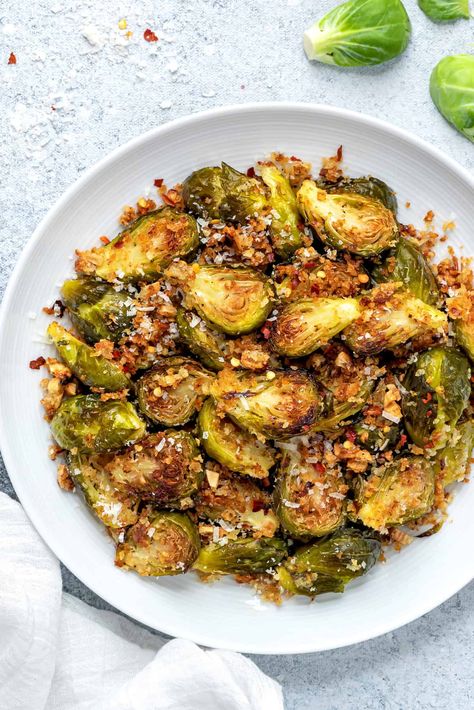 My Parmesan Garlic Roasted Brussels Sprouts are an utter delight. With crispy bits of toasted panko, a bit of heat from chili peppers and a dose of nutty, creamy cheese, this is the cool weather side dish you need right now. Thanksgiving Brussels Sprouts, Brussels Sprout Recipes, Vegan Thanksgiving Side Dishes, Brussels Sprouts Recipes, Baked Brussel Sprouts, Sprouts Recipes, Crispy Brussel Sprouts, Brussel Sprout Recipes Roasted, Roasted Sprouts