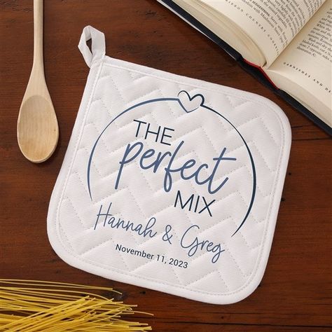 Personalize with names and line of textChoose from multiple colors White, cotton potholder features concentrated quilt patterns to keep the filling material evenly distributed, even after repeated washingsLined with silver acrylic coated cottonMeasures 8" x 8"Machine washSold IndividuallyImported Celebrate your new married status in the kitchen with our The Perfect Mix Personalized Apron & Potholder.  Makes a great bridal shower, wedding or anniversary gift! Personalized Kitchen Items, Personalized Kitchen Towels, Personalized Apron, Cricut Supplies, Cricut Wedding, Wedding Shower Gifts, Quick Crafts, Personalized Aprons, Washing Line