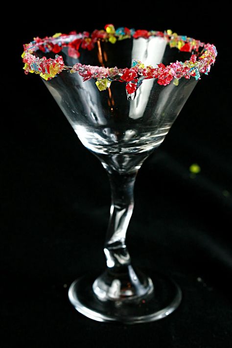 A martini glass with a candied cocktail rim, against a black background. Bartender Game, Birthday Cake Martini, Pina Colada Rum, Bday Vibes, Home Bartender, Lemonade Cupcakes, Mango Mojito, Candy Cocktails, Apple Martini