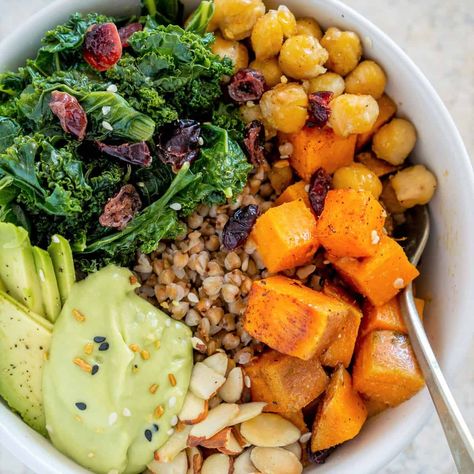 Vegan Buckwheat Bowls with Roasted Sweet Potato, Chickpeas, and Kale, with a vegan avocado cream sauce, crunchy toasted almonds, and sweet dried cranberries. Gluten free (yes, buckwheat is NOT wheat!), healthy, filling, tasty. #buckwheatrecipes #buckwheat #veganbowls Sweet Potato Chickpeas, Sweet And Sour Cabbage, Buckwheat Recipes, Creamy Avocado Sauce, Buckwheat Groats, Sauteed Kale, Roasted Sweet Potato, Avocado Sauce, Vegan Bowls