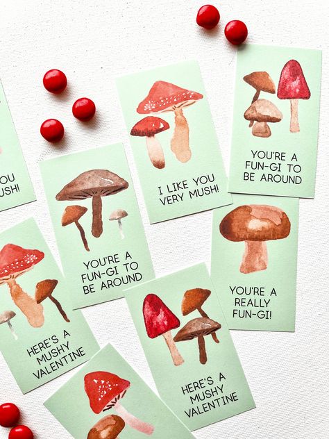 "The perfect Valentine cards for a real \"fun-gi\" who loves mushrooms, forests, and nature. A quick and easy way to make DIY Valentine cards at home: this digital download is a PDF features 8 mushroom-themed mini Valentine's Day cards that can be printed and cut out today. Each card features a different group of watercolor mushrooms with sweet puns for friendship and Valentine's Day. These Valentines are blank on the back side, allowing plenty of space for kids to write their To/From names. PLEASE NOTE: This is a printable, instant download product. No physical item will be mailed to your home address. Thank you! SIZE The file is a letter-sized, 8.5\" x 11\" PDF with eight 3.5\" x 2\" cards on the page. CARDS INCLUDED: - \"I like you very mush\" version 1 - \"I like you very mush\" versio Nature Valentines Cards, Mushroom Valentine Card, Friendship Valentines Cards, Homemade Valentines Day Cards For Kids, Homemade Valentines For Kids, Mushroom Valentine, Mushroom Puns, Sweet Puns, Mushroom Card