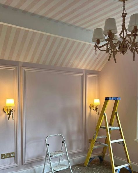 Stephanie Moreton on Instagram: "CANDY STRIPES 💕 As soon as I saw this vaulted ceiling I knew I wanted to wallpaper the whole area!! Thankfully the client loved the idea as much as me!!! …this is going to be something special….lots more to add including custom blinds 💕 . . . . . #pink #pinkbedroom #girlsbedroom #girliebedroom #stripedwallpaper #walllights #chandelier #panelling #wallpanelling #bedroom #bedroominspo #design #designinspo #designservice #homedesign #homeinspo #beverleyhillshotel Angled Ceiling Wallpaper, Vaulted Ceiling Wallpaper, Painted Ceiling Kids Room, Wallpanelling Bedroom, Striped Wallpaper Ceiling, Slanted Ceiling Nursery, Pink Panelling, Striped Walls Bedroom, Aurora Bedroom