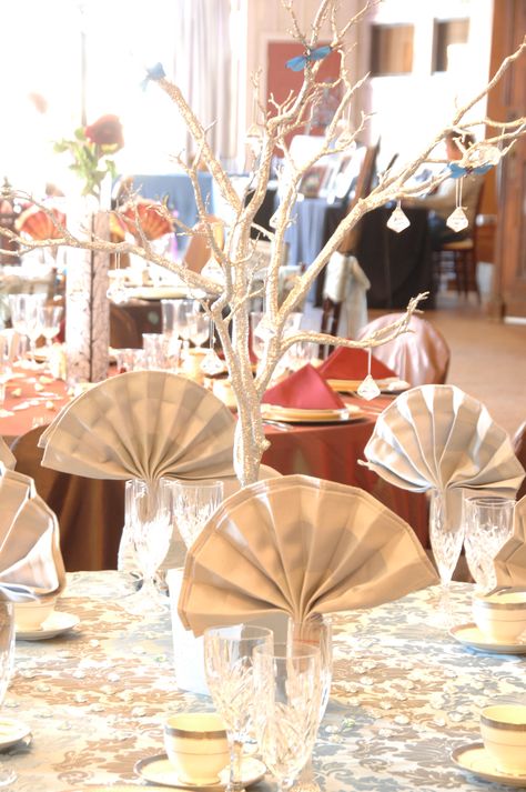 Tan cotton fan folded napkin in iced beverage glass with a manzilla branch as centerpiece. Fan Napkin Fold, Folding Napkins, Ajanta Caves, Ranch Weddings, Standing Fans, Napkin Folding, Ranch Wedding, Party Themes, Table Settings