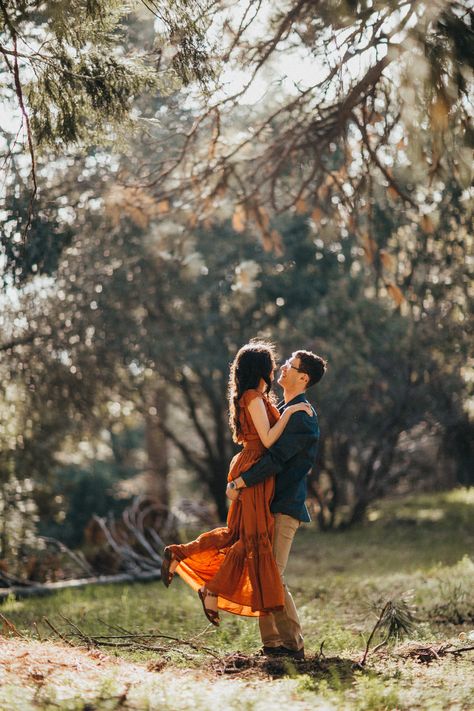 Melody wore a beautiful, bohemian, rust-colored dress for their engagement photos at Lake Silverwood in Southern California. Rust Photoshoot, Fall Engagement Photos Dress, Rust Dress Engagement Photos, Rust Engagement Pictures, Orange Dress Engagement Photos, Burnt Orange Engagement Photos, Wooded Engagement Photos Fall, Engagement Photos Redwoods, Fall Foliage Engagement Photos