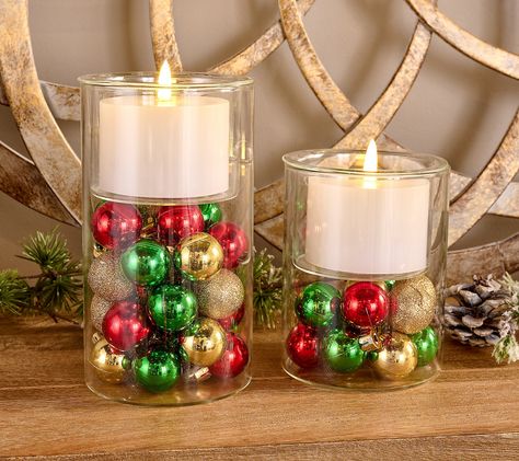 Add a touch of festive charm to your home with this Lightscapes set of two candle holders. These glass holders come with flameless candles, creating a warm and inviting glow without the hassle of real flames. Perfect for holiday decor, each holder features an assortment of ornaments for added cheer. From Lightscapes.    Original item is H466113. This product may be a customer return, vendor sample, or on-air display and is not in its originally manufactured condition. It may not be new. In some instances, these items are repackaged by QVC. Terra Cotta Pot Candle Holder, Present Centerpieces, Holiday Party Centerpieces Corporate, Christmas Ornament Centerpieces, Holiday Party Centerpieces, Candle Play, Christmas Centerpieces Cheap, Kwanzaa Crafts, Cheap Centerpieces